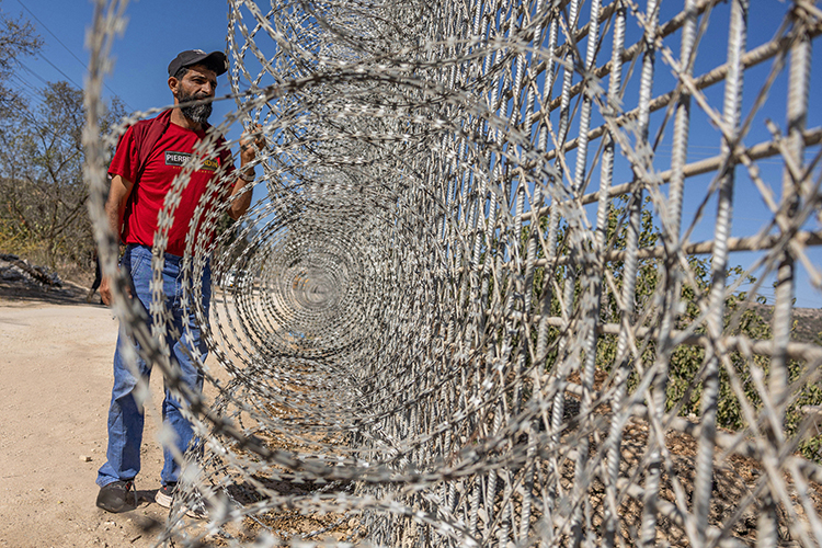 A resident of Sinjil near a fence built on town land, October 2025. Photo by Avishay Mohar, ActiveStills
